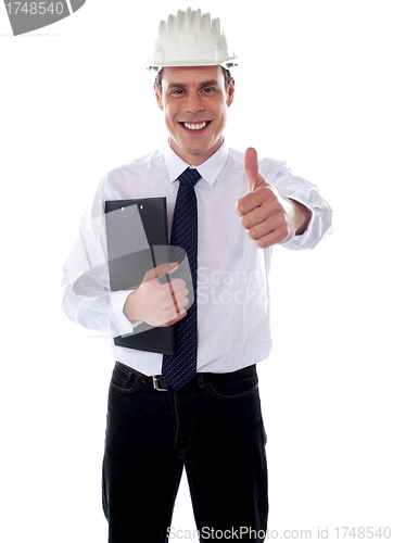 Image of Cheerful architect gesturing thumbs up
