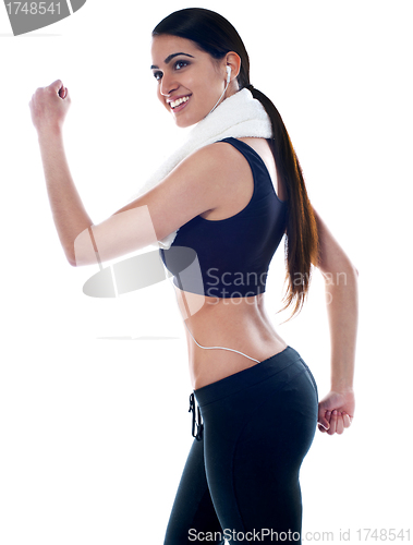 Image of Young fit woman listening to music