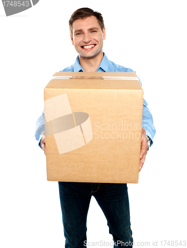 Image of Casual guy carrying packed cardboard boxes