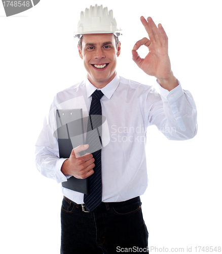 Image of Handsome engineer showing okay gesture