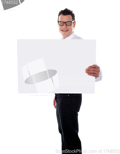 Image of Smiling guy holding banner ad with one hand