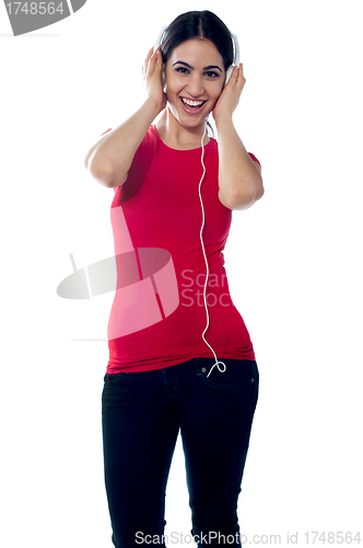 Image of Trendy girl teenager tuned into music