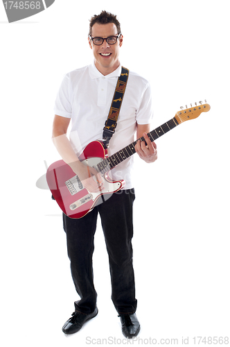 Image of Full shot of a young man with guitar