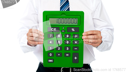 Image of Closeup of a green calculator. Man holding it