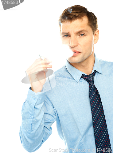 Image of Young businessman smoking cigarette