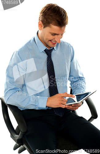 Image of Businessman watching videos on tablet pc