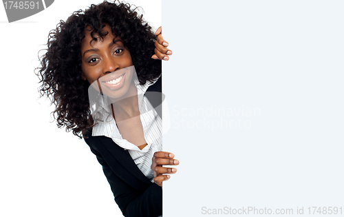 Image of Businesswoman holding a long blank banner ad