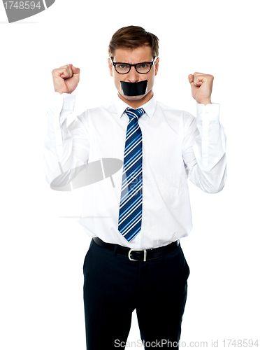Image of Angry young man with duct tape on his mouth
