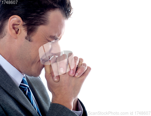 Image of Business executive praying to god