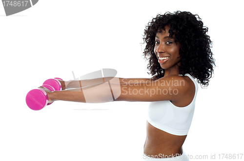 Image of Fitness freak exercising with dumbbells