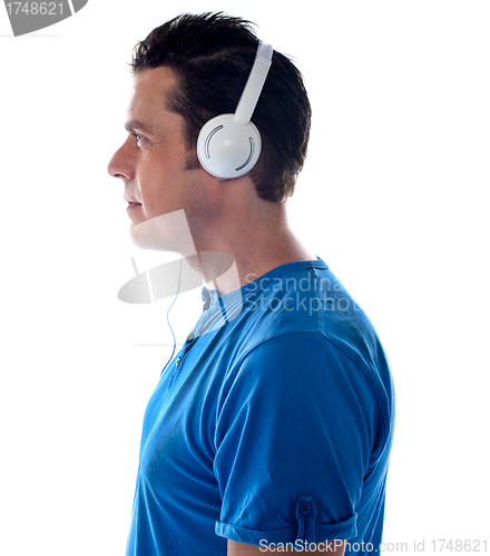 Image of Side pose of a man with headphones