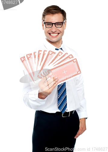 Image of Cheerful man holding up playing cards