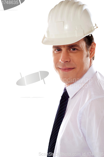 Image of Smiling male architect wearing hard hat