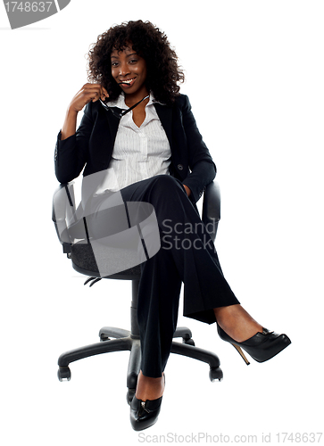 Image of Corporate lady posing with eyeglasses in hand