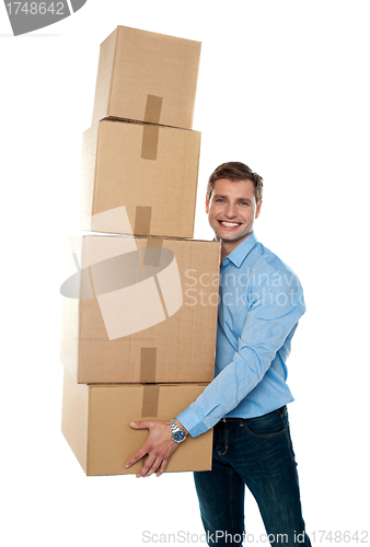 Image of Smiling male holding stack of cartons