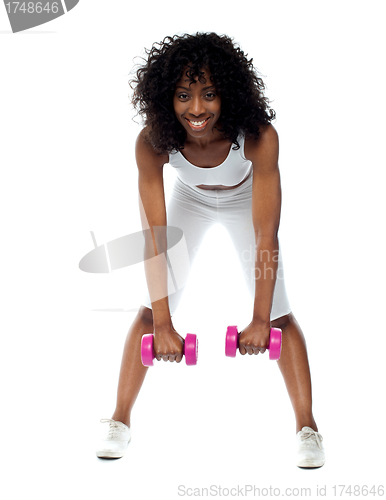 Image of Fit woman exercising. Bending down