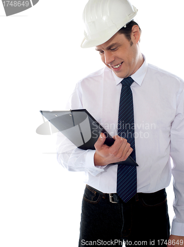 Image of An architect reviewing report