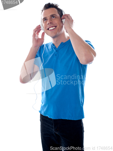 Image of Attractive caucasian male listening music