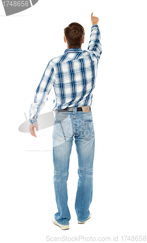 Image of Rear view of a male indicating towards copy space
