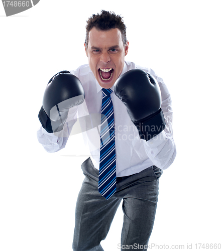 Image of Angry corporate male wearing boxing gloves