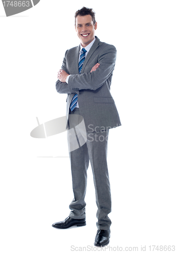 Image of Businessman standing with arms crossed