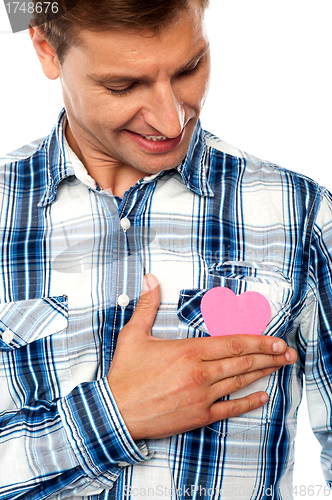 Image of Handsome man holding paper heart