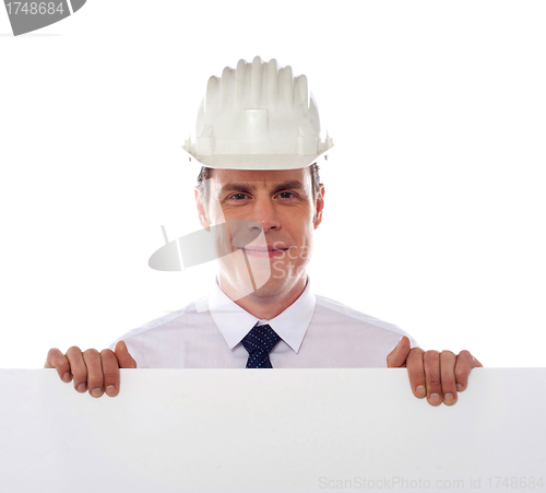 Image of An architect holding blank white placard