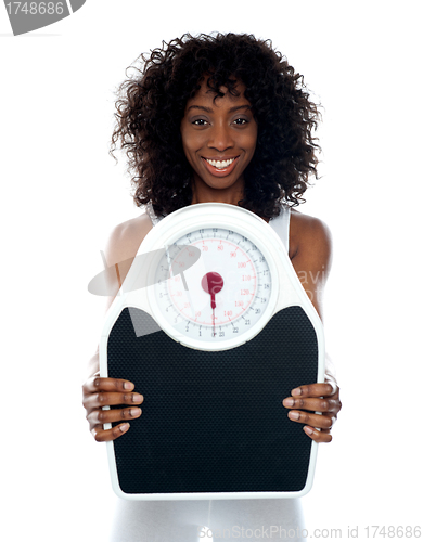 Image of African athlete showing weighing scale