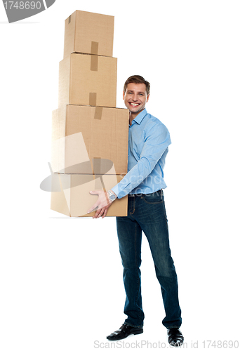 Image of Young man with stack of cartons