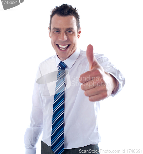 Image of Young executive showing thumbs up