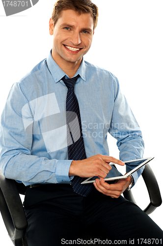 Image of Relaxed businessman using tablet pc