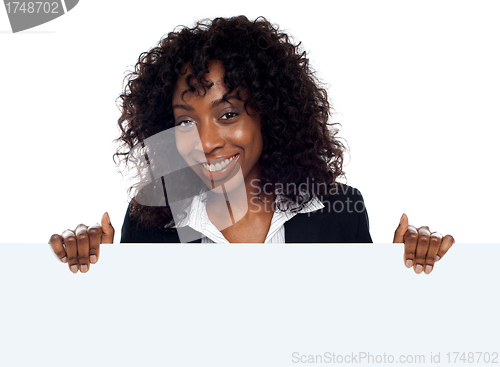 Image of Young woman holding blank white placard