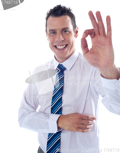Image of Young associate gesturing excellent sign
