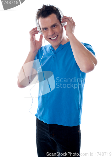 Image of Attractive guy holding headphones