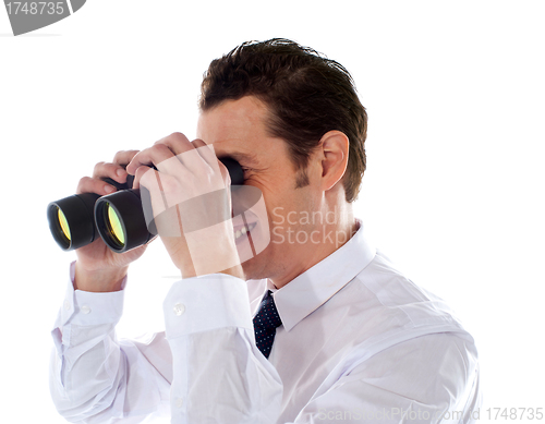 Image of Male executive looking through binoculars