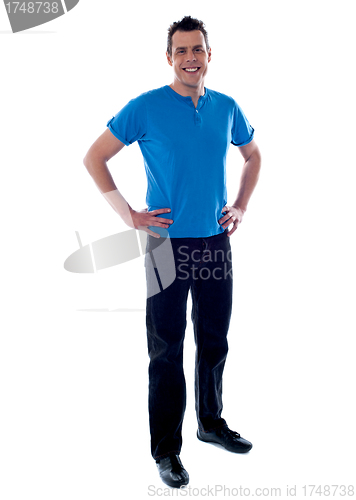 Image of Handsome guy with hands on waist