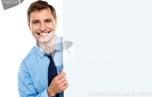 Image of Business man holding a long blank banner ad