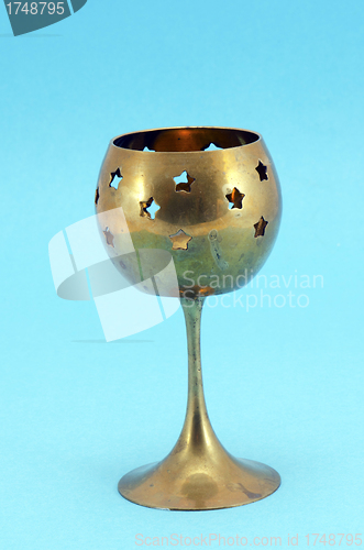 Image of Bronze glass candlestick on blue background 