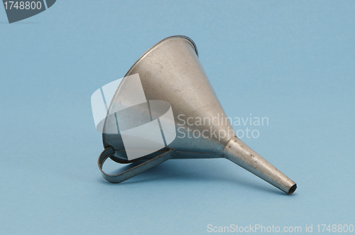 Image of Ancient metal aluminum funnel on blue background 