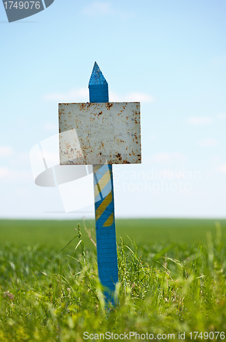 Image of Weathered plaque on a grassy land plot