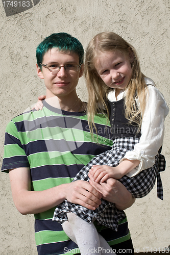 Image of little sister on brother's hands