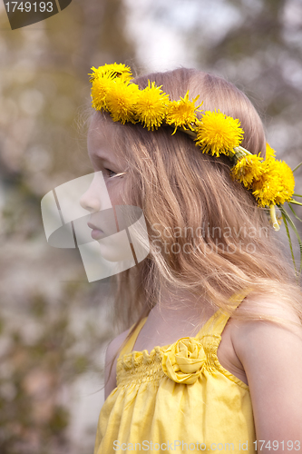Image of profile portrait of little girl in dandelion wreath