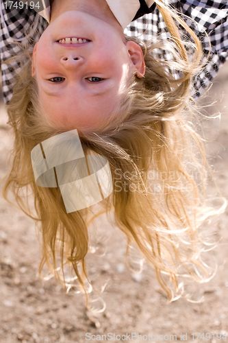 Image of head over heels face of little girl