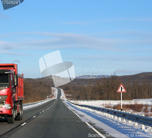 Image of The red truck on a winter road.