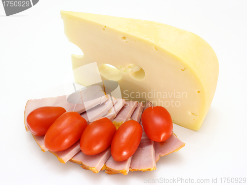 Image of Cheese with holes and red tomatoes 