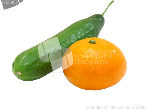 Image of The fresh green cucumber with a tangerine 