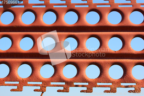 Image of An old rusty fence with holes