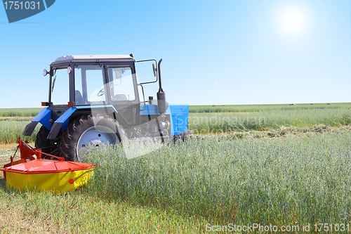 Image of Tractor in a field, agricultural scene in summer