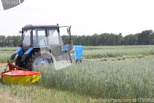 Image of Tractor in a field, agricultural scene in summer