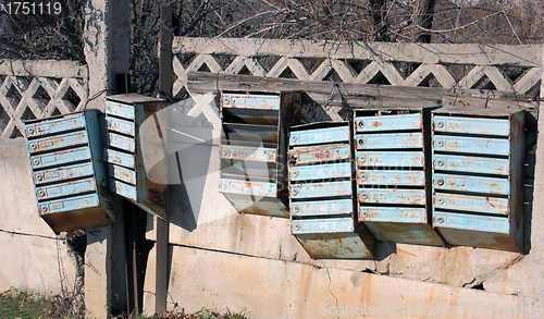 Image of Old mailboxes are on the fence